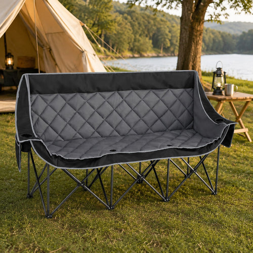 Gray three person folding camping chair fully opened at a lakeside campsite