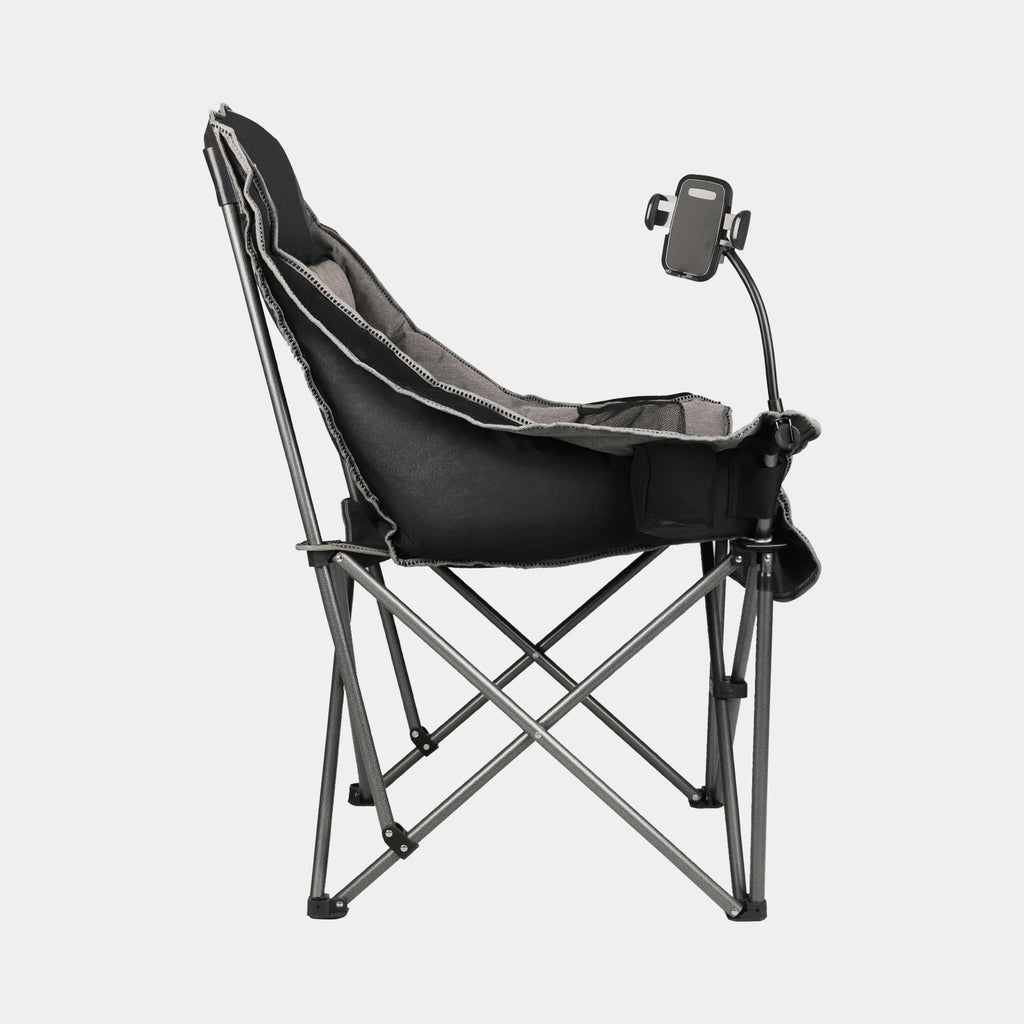 Oversized black and gray folding camping chair opened at a lakeside campsite