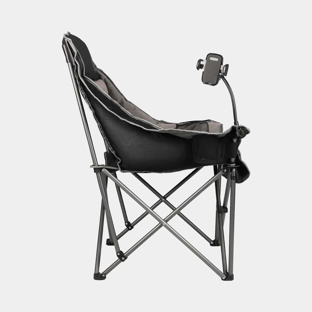 Oversized black and gray folding camping chair opened at a lakeside campsite