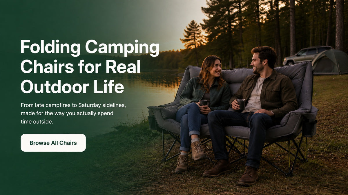 Couple relaxing on a padded double folding camping chair beside a lake at sunset